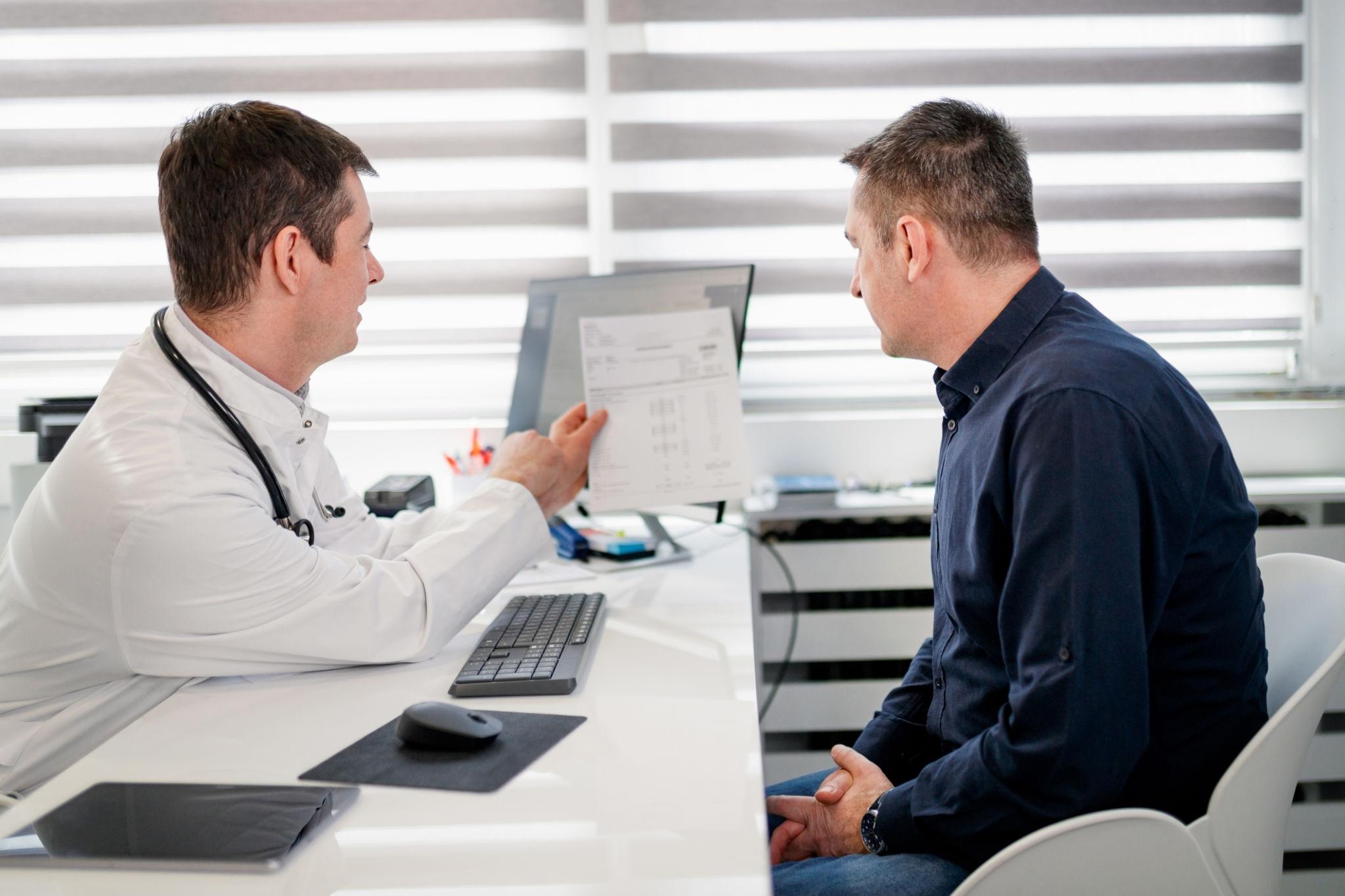 Physician monitoring a male patient during testosterone hormone therapy